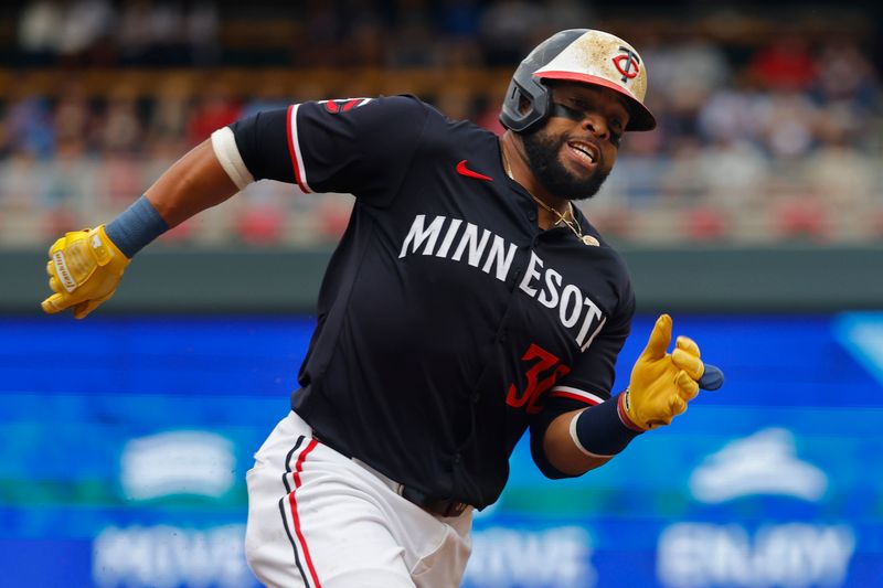 Jun 20, 2024; Minneapolis, Minnesota, USA; Minnesota Twins first baseman Carlos Santana (30) rounds third base on his way to scoring against the Tampa Bay Rays in the second inning at Target Field. Mandatory Credit: Bruce Kluckhohn-USA TODAY Sports