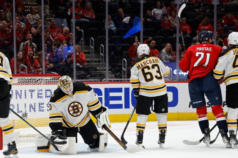 Oct 5, 2024; Washington, District of Columbia, USA; Washington Capitals center Aliaksei Protas (21) celebrates after scoring a goal on Boston Bruins goaltender Brandon Bussi (30) in the first period at Capital One Arena. Mandatory Credit: Geoff Burke-Imagn Images