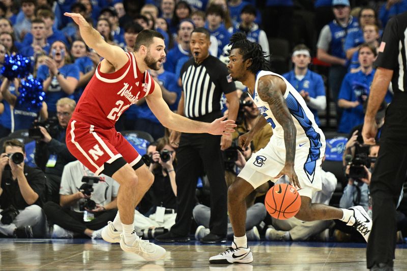 Nov 22, 2024; Omaha, Nebraska, USA;  Creighton Bluejays guard Jamiya Neal (5) dribbles against Nebraska Cornhuskers guard Rollie Worster (24) during the first half at CHI Health Center Omaha. Mandatory Credit: Steven Branscombe-Imagn Images