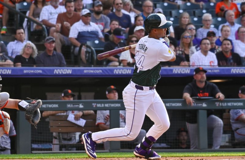 Jul 20, 2024; Denver, Colorado, USA;  Colorado Rockies shortstop Ezequiel Tovar (14) gets a base hit against the San Francisco Giants in the first inning at Coors Field. Mandatory Credit: John Leyba-USA TODAY Sports