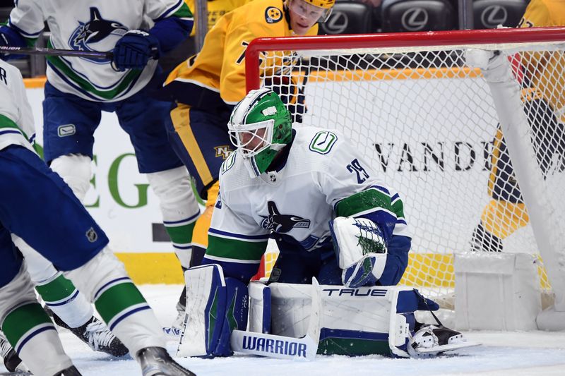 Dec 19, 2023; Nashville, Tennessee, USA; Vancouver Canucks goaltender Casey DeSmith (29) makes a save during the third period against the Nashville Predators at Bridgestone Arena. Mandatory Credit: Christopher Hanewinckel-USA TODAY Sports