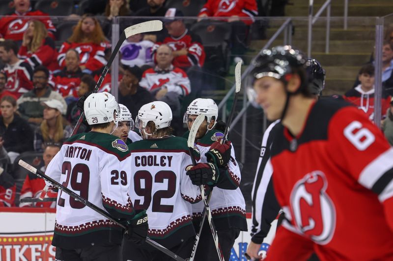 Oct 13, 2023; Newark, New Jersey, USA; The Arizona Coyotes celebrate a goal by Arizona Coyotes center Nick Schmaltz (8) against the New Jersey Devils during the third period at Prudential Center. Mandatory Credit: Ed Mulholland-USA TODAY Sports