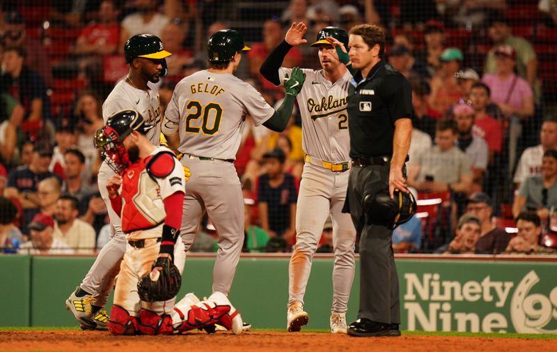 Jul 9, 2024; Boston, Massachusetts, USA; Oakland Athletics second baseman Zack Gelof (20) is congratulated after hitting a three run home run against the Boston Red Sox in the ninth inning at Fenway Park. Mandatory Credit: David Butler II-USA TODAY Sports