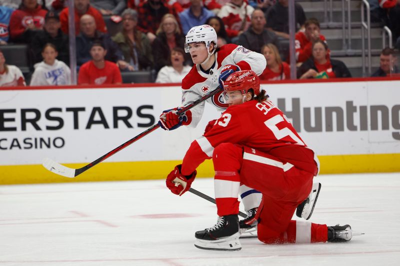 Apr 15, 2024; Detroit, Michigan, USA;  Montreal Canadiens right wing Cole Caufield (22) shoots while defended by Detroit Red Wings defenseman Moritz Seider (53) in the third periodat Little Caesars Arena. Mandatory Credit: Rick Osentoski-USA TODAY Sports