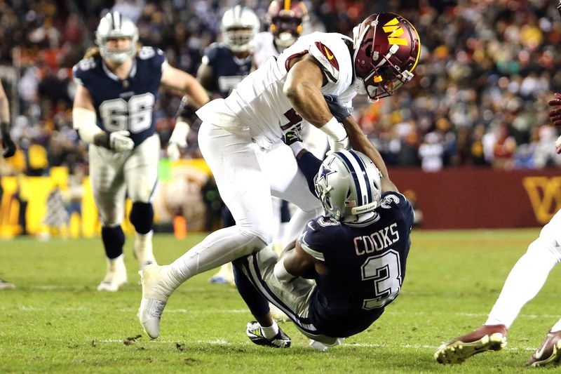 Washington Commanders linebacker Khaleke Hudson (47) lays a hard hit on Dallas Cowboys wide receiver Brandin Cooks (3)during an NFL football game, Sunday, January 7, 2024 in Landover, Md. (AP Photo/Daniel Kucin Jr.)