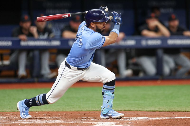 Apr 24, 2024; St. Petersburg, Florida, USA;  Tampa Bay Rays shortstop Jose Caballero (7) hits an rbi single against the Detroit Tigers in the second inning at Tropicana Field. Mandatory Credit: Nathan Ray Seebeck-USA TODAY Sports