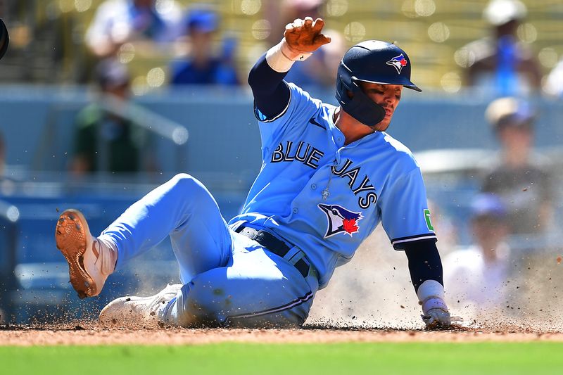 Jul 26, 2023; Los Angeles, California, USA; Toronto Blue Jays second baseman Cavan Biggio (8) scores a run against the Los Angeles Dodgers during the eighth inning at Dodger Stadium. Mandatory Credit: Gary A. Vasquez-USA TODAY Sports