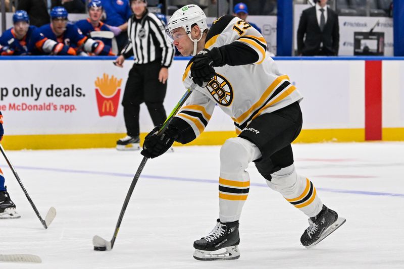 Nov 27, 2024; Elmont, New York, USA;  Boston Bruins center Charlie Coyle (13) attempts a shot against the New York Islanders during the first period at UBS Arena. Mandatory Credit: Dennis Schneidler-Imagn Images