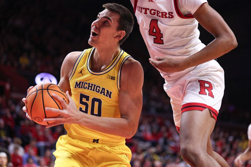 Feb 1, 2025; Piscataway, New Jersey, USA; Michigan Wolverines center Vladislav Goldin (50) goes to the basket as Rutgers Scarlet Knights guard Ace Bailey (4) defends during the first half at Jersey Mike's Arena. Mandatory Credit: Vincent Carchietta-Imagn Images