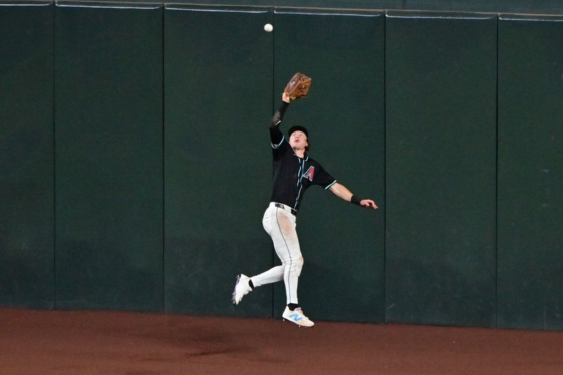 Aug 29, 2024; Phoenix, Arizona, USA;  Arizona Diamondbacks outfielder Jake McCarthy (31) catches a fly ball in the sixth inning against the New York Mets at Chase Field. Mandatory Credit: Matt Kartozian-USA TODAY Sports