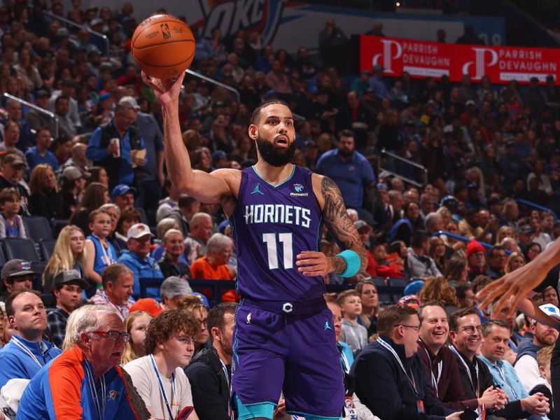 OKLAHOMA CITY, OK - FEBUARY 2:  Cody Martin #11 of the Charlotte Hornets passes the ball during the game  on February 2, 2024 at Paycom Arena in Oklahoma City, Oklahoma. NOTE TO USER: User expressly acknowledges and agrees that, by downloading and or using this photograph, User is consenting to the terms and conditions of the Getty Images License Agreement. Mandatory Copyright Notice: Copyright 2024 NBAE (Photo by Zach Beeker/NBAE via Getty Images)