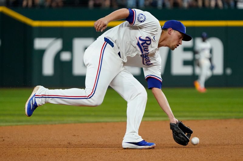 Aug 31, 2024; Arlington, Texas, USA; Texas Rangers shortstop Corey Seager (5) fields a ground ball during the eighth inning against the Oakland Athletics at Globe Life Field. Mandatory Credit: Raymond Carlin III-USA TODAY Sports