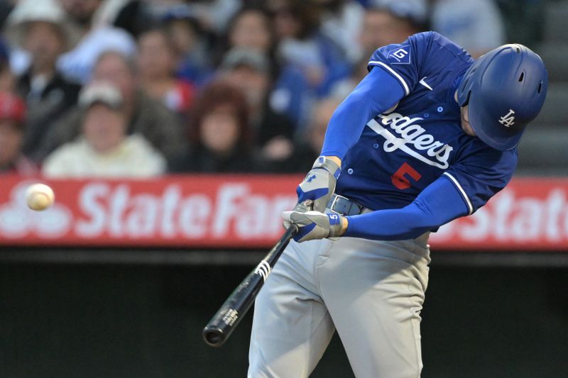 Mar 26, 2024; Anaheim, California, USA; Los Angeles Dodgers first baseman Freddie Freeman (5) hits a solo home run in the third inning against the Los Angeles Angels at Angel Stadium. Mandatory Credit: Jayne Kamin-Oncea-USA TODAY Sports