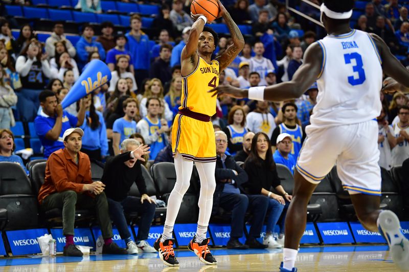 Mar 2, 2023; Los Angeles, California, USA; Arizona State Sun Devils guard Desmond Cambridge Jr. (4) shoots against UCLA Bruins forward Adem Bona (3) during the first half at Pauley Pavilion. Mandatory Credit: Gary A. Vasquez-USA TODAY Sports