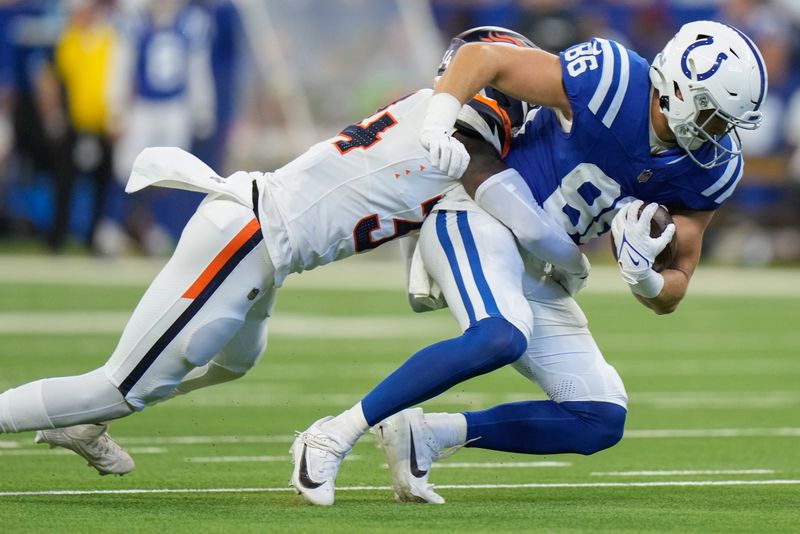 Denver Broncos safety Keidron Smith (43) tackles Indianapolis Colts tight end Will Mallory (86) during the second quarter of a preseason NFL football game, Sunday, Aug. 11, 2024, in Westfield, Ind. (AP Photo/AJ Mast)