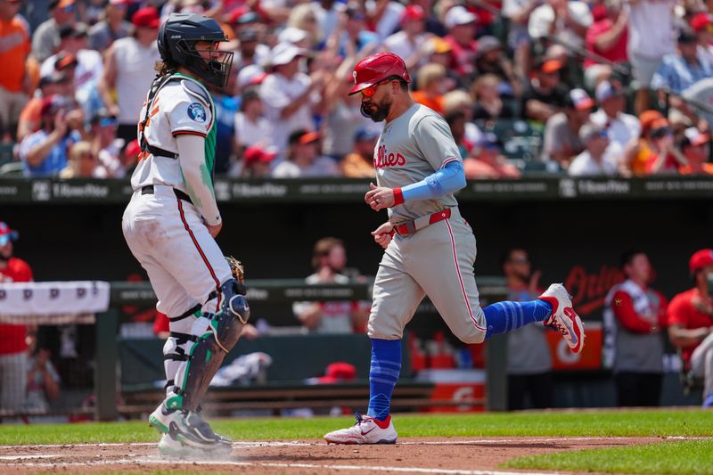 Jun 16, 2024; Baltimore, Maryland, USA; Philadelphia Phillies designated hitter Kyle Schwarber (12) scores a run on Philadelphia Phillies third baseman Alec Bohm (not pictured) RBI single against the Baltimore Orioles during the fifth inning at Oriole Park at Camden Yards. Mandatory Credit: Gregory Fisher-USA TODAY Sports