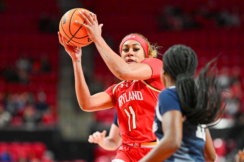 Feb 18, 2024; College Park, Maryland, USA;  Maryland Terrapins guard Jakia Brown-Turner (11) makes a move towards the basket in front of Penn State Nittany Lions guard Jayla Oden (12) during the second  half at Xfinity Center. Mandatory Credit: Tommy Gilligan-USA TODAY Sports