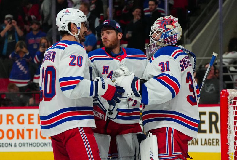 Mar 12, 2024; Raleigh, North Carolina, USA; New York Rangers goaltender Igor Shesterkin (31) goaltender Jonathan Quick (32) and left wing Chris Kreider (20) celebrate their victory against the Carolina Hurricanes at PNC Arena. Mandatory Credit: James Guillory-USA TODAY Sports