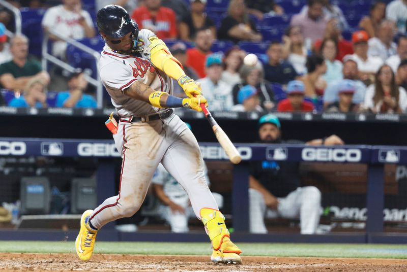 Sep 15, 2023; Atlanta Braves right fielder Ronald Acuna Jr. (13) hits a sacrifice fly against the Miami Marlins during the fourth inning at loanDepot Park. Mandatory Credit: Rhona Wise-USA TODAY Sports