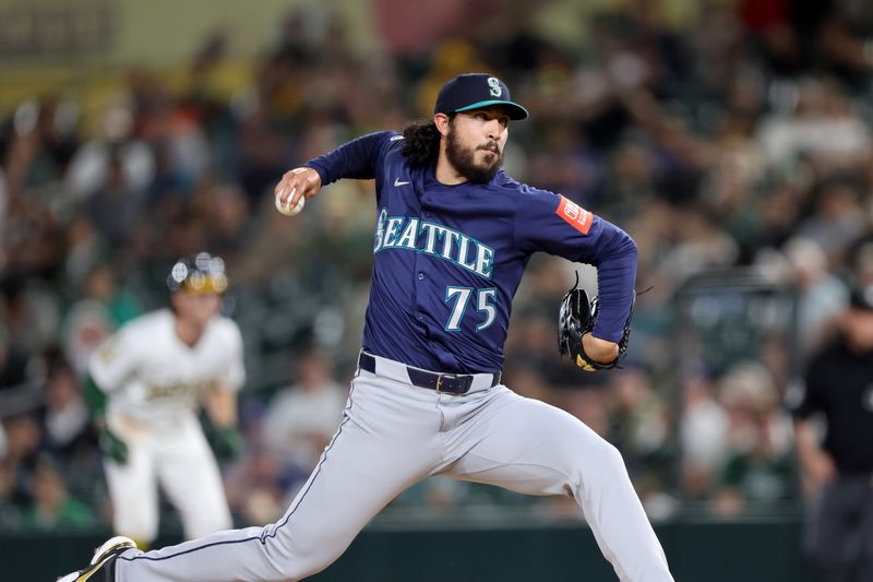 May 5, 2025; West Sacramento, California, USA; Seattle Mariners pitcher Andres Munoz (75) throws against the Athletics during the tenth inning at Sutter Health Park. Mandatory Credit: Dennis Lee-Imagn Images