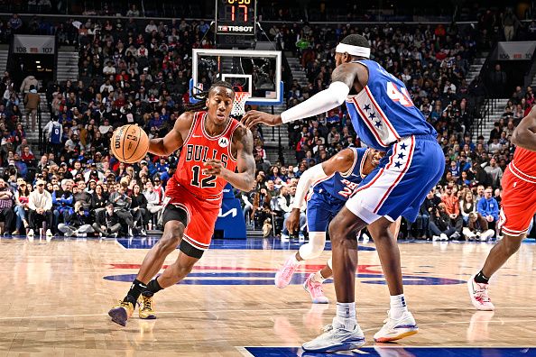 PHILADELPHIA, PA - JANUARY 2: Ayo Dosunmu #12 of the Chicago Bulls dribbles the ball during the game against the Philadelphia 76ers on January 2, 2024 at the Wells Fargo Center in Philadelphia, Pennsylvania NOTE TO USER: User expressly acknowledges and agrees that, by downloading and/or using this Photograph, user is consenting to the terms and conditions of the Getty Images License Agreement. Mandatory Copyright Notice: Copyright 2024 NBAE (Photo by David Dow/NBAE via Getty Images)