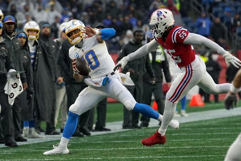 Los Angeles Chargers quarterback Justin Herbert (10) is pushed out of bounds by New England Patriots linebacker Josh Uche (55) during the first half of an NFL football game, Sunday, Dec. 3, 2023, in Foxborough, Mass. (AP Photo/Steven Senne)