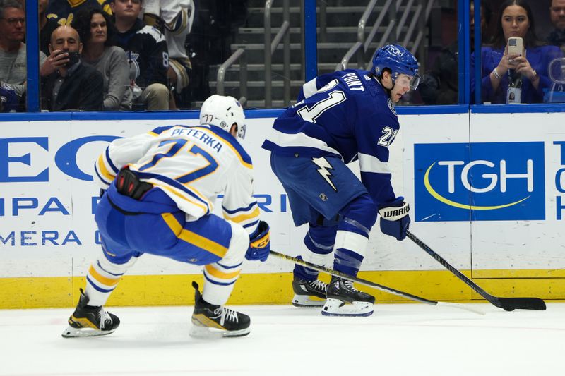 Feb 29, 2024; Tampa, Florida, USA;  Tampa Bay Lightning center Brayden Point (21) controls the puck from Buffalo Sabres right wing JJ Peterka (77) in the first period  at Amalie Arena. Mandatory Credit: Nathan Ray Seebeck-USA TODAY Sports