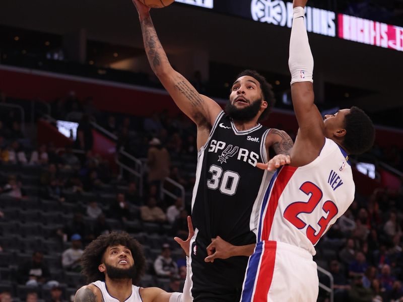 DETROIT, MICHIGAN - JANUARY 10: Julian Champagnie #30 of the San Antonio Spurs drives to the basket against Jaden Ivey #23 of the Detroit Pistons during the second half at Little Caesars Arena on January 10, 2024 in Detroit, Michigan. San Antonio Spurs won the game 130-108. NOTE TO USER: User expressly acknowledges and agrees that, by downloading and or using this photograph, User is consenting to the terms and conditions of the Getty Images License  (Photo by Gregory Shamus/Getty Images)