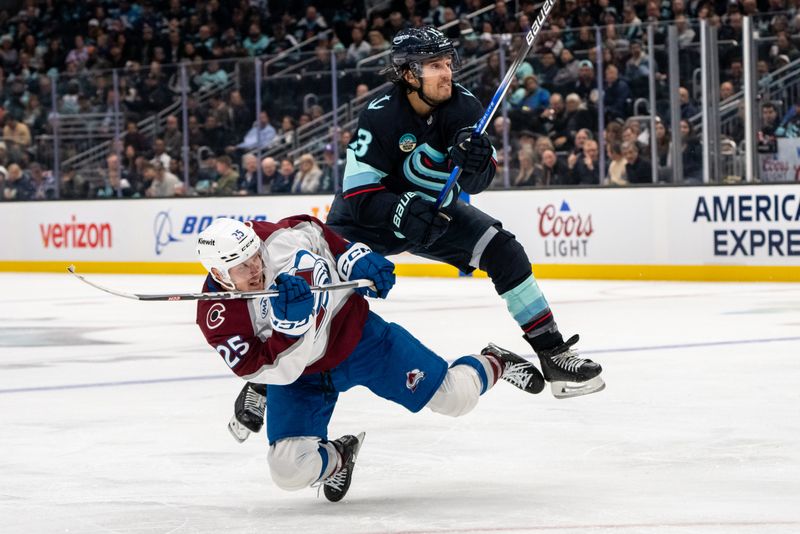 Oct 22, 2024; Seattle, Washington, USA;  Seattle Kraken forward Brandon Tanev (13) checks Colorado Avalanche forward Logan O'Connor (25) during the third period at Climate Pledge Arena. Mandatory Credit: Stephen Brashear-Imagn Images