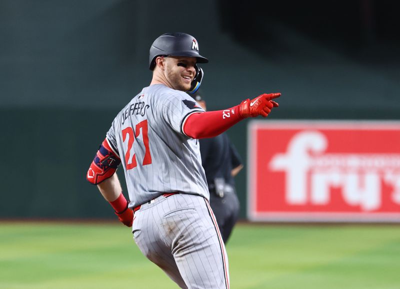 Jun 25, 2024; Phoenix, Arizona, USA; Minnesota Twins catcher Ryan Jeffers celebrates after hitting a three run home run in the seventh inning against the Arizona Diamondbacks at Chase Field. Mandatory Credit: Mark J. Rebilas-USA TODAY Sports