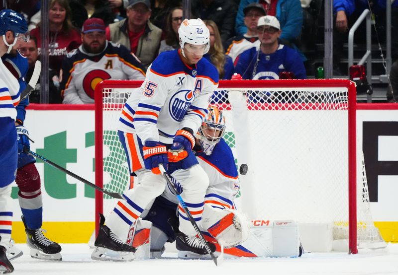 Nov 30, 2024; Denver, Colorado, USA; Edmonton Oilers defenseman Darnell Nurse (25) assists on a save on goaltender Stuart Skinner (74) in the third period against the Colorado Avalanche at Ball Arena. Mandatory Credit: Ron Chenoy-Imagn Images