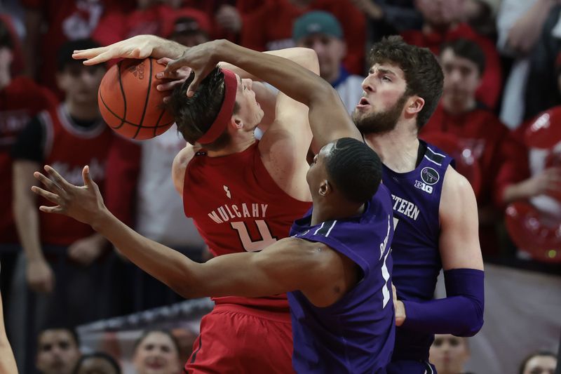 Mar 5, 2023; Piscataway, New Jersey, USA; Northwestern Wildcats forward Gus Hurlburt (54) blocks a shot by Rutgers Scarlet Knights guard Paul Mulcahy (4) in front of guard Boo Buie (0) during the first half at Jersey Mike's Arena. Mandatory Credit: Vincent Carchietta-USA TODAY Sports