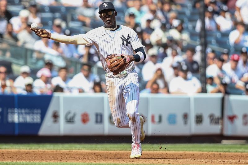 Aug 25, 2024; Bronx, New York, USA;  New York Yankees third baseman Jazz Chisholm Jr. (13) throws a runner out at first base in the third inning against the Colorado Rockies at Yankee Stadium. Mandatory Credit: Wendell Cruz-USA TODAY Sports