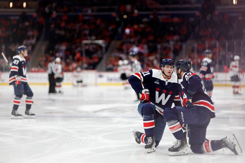 Feb 20, 2024; Washington, District of Columbia, USA; Washington Capitals center Aliaksei Protas (21) talks with Capitals right wing Tom Wilson (43) prior to the start of the third period against the New Jersey Devils at Capital One Arena. Mandatory Credit: Geoff Burke-USA TODAY Sports