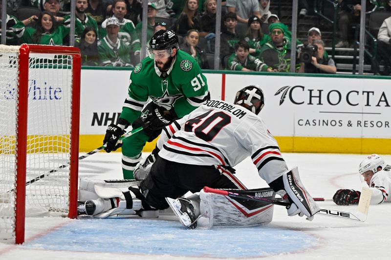 Nov 7, 2024; Dallas, Texas, USA; Chicago Blackhawks goaltender Arvid Soderblom (40) stops a short by Dallas Stars center Tyler Seguin (91) during the second period at the American Airlines Center. Mandatory Credit: Jerome Miron-Imagn Images