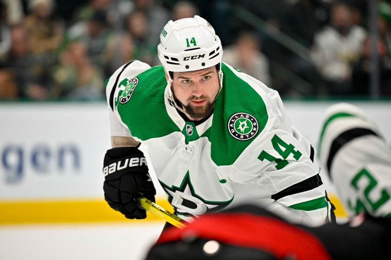 Jan 25, 2023; Dallas, Texas, USA; Dallas Stars left wing Jamie Benn (14) looks for the puck in the Carolina Hurricanes zone during the second period at the American Airlines Center. Mandatory Credit: Jerome Miron-USA TODAY Sports