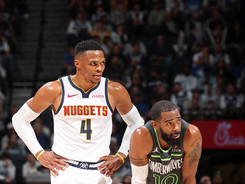 MINNEAPOLIS, MN -  NOVEMBER 1: Russell Westbrook #4 of the Denver Nuggets and Mike Conley #10 of the Minnesota Timberwolves look on during the game on November 1, 2024 at Target Center in Minneapolis, Minnesota. NOTE TO USER: User expressly acknowledges and agrees that, by downloading and or using this Photograph, user is consenting to the terms and conditions of the Getty Images License Agreement. Mandatory Copyright Notice: Copyright 2024 NBAE (Photo by David Sherman/NBAE via Getty Images)