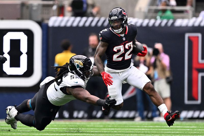 Jacksonville Jaguars defensive tackle DaVon Hamilton (52) attempt to tackle Houston Texans running back Cam Akers (22) in the second quarter during an NFL football game, Sunday, Sept. 29, 2024 in Houston. (AP Photo/Maria Lysaker)