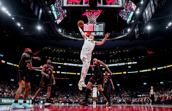 TORONTO, ON - DECEMBER 23: Lauri Markkanen #23 of the Utah Jazz dunks against the Toronto Raptors during the first half of their basketball game at the Scotiabank Arena on December 23, 2023 in Toronto, Ontario, Canada. NOTE TO USER: User expressly acknowledges and agrees that, by downloading and/or using this Photograph, user is consenting to the terms and conditions of the Getty Images License Agreement. (Photo by Mark Blinch/Getty Images)