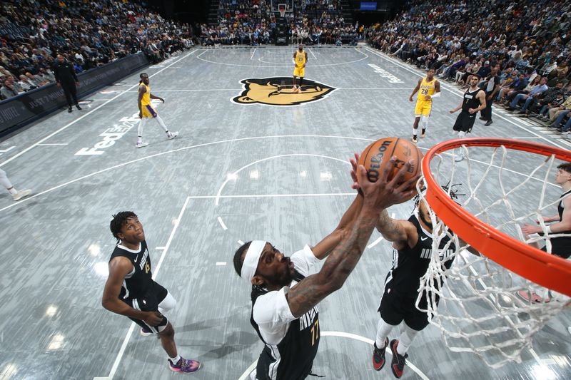 MEMPHIS, TN - MARCH 27: DeJon Jarreau #77 of the Memphis Grizzlies goes up for the rebound during the game against the Los Angeles Lakers on March 27, 2024 at FedExForum in Memphis, Tennessee. NOTE TO USER: User expressly acknowledges and agrees that, by downloading and or using this photograph, User is consenting to the terms and conditions of the Getty Images License Agreement. Mandatory Copyright Notice: Copyright 2024 NBAE (Photo by Joe Murphy/NBAE via Getty Images)