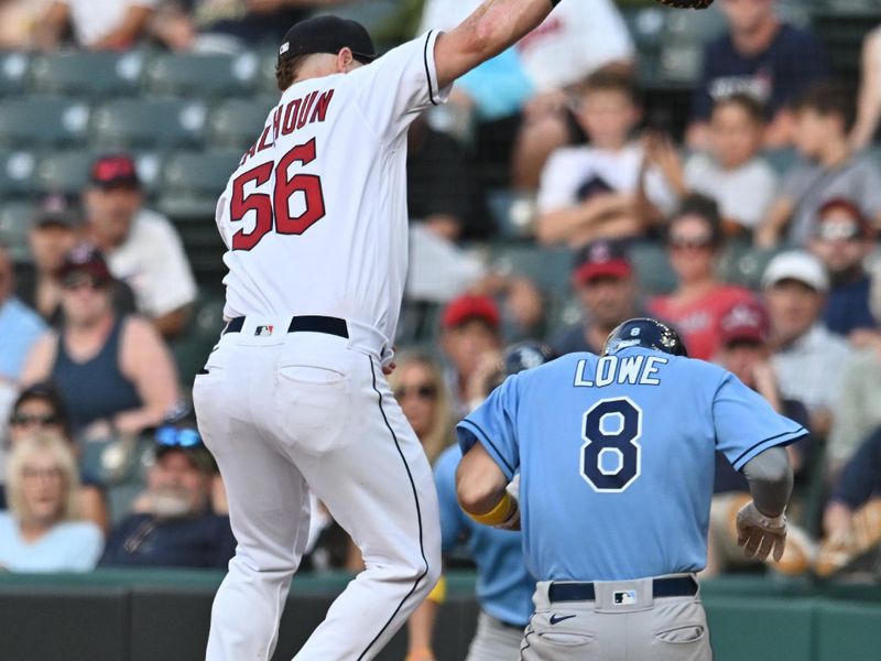 Sep 3, 2023; Cleveland, Ohio, USA; Tampa Bay Rays second baseman Brandon Lowe (8) is safe at first as Cleveland Guardians first baseman Kole Calhoun (56) jumps for the throw from relief pitcher Eli Morgan (not pictured) during the ninth inning at Progressive Field. Mandatory Credit: Ken Blaze-USA TODAY Sports