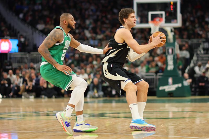 MILWAUKEE, WISCONSIN - APRIL 09: Brook Lopez #11 of the Milwaukee Bucks is defended by Xavier Tillman #26 of the Boston Celtics during a game at Fiserv Forum on April 09, 2024 in Milwaukee, Wisconsin. NOTE TO USER: User expressly acknowledges and agrees that, by downloading and or using this photograph, User is consenting to the terms and conditions of the Getty Images License Agreement. (Photo by Stacy Revere/Getty Images)