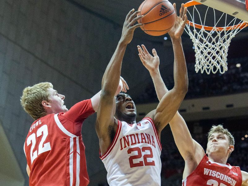 Jan 14, 2023; Bloomington, Indiana, USA; Indiana Hoosiers forward Jordan Geronimo (22) and Wisconsin Badgers forward Steven Crowl (22) and forward Markus Ilver (35) fight for a rebound in the first half at Simon Skjodt Assembly Hall. Mandatory Credit: Trevor Ruszkowski-USA TODAY Sports