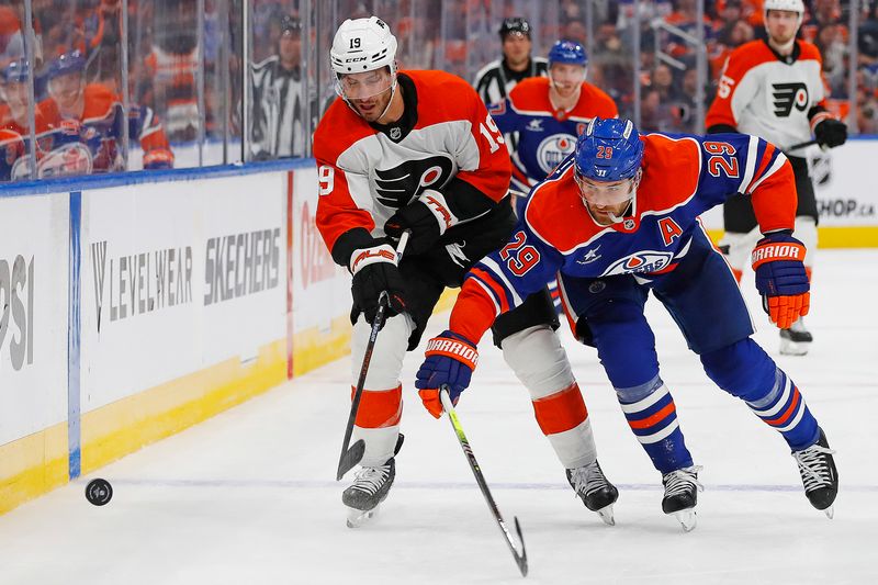 Oct 15, 2024; Edmonton, Alberta, CAN; Edmonton Oilers forward Leon Draisaitl (29) and Philadelphia Flyers forward Garnet Hathaway (19) battle along the boards for a loose puck during the second period at Rogers Place. Mandatory Credit: Perry Nelson-Imagn Images