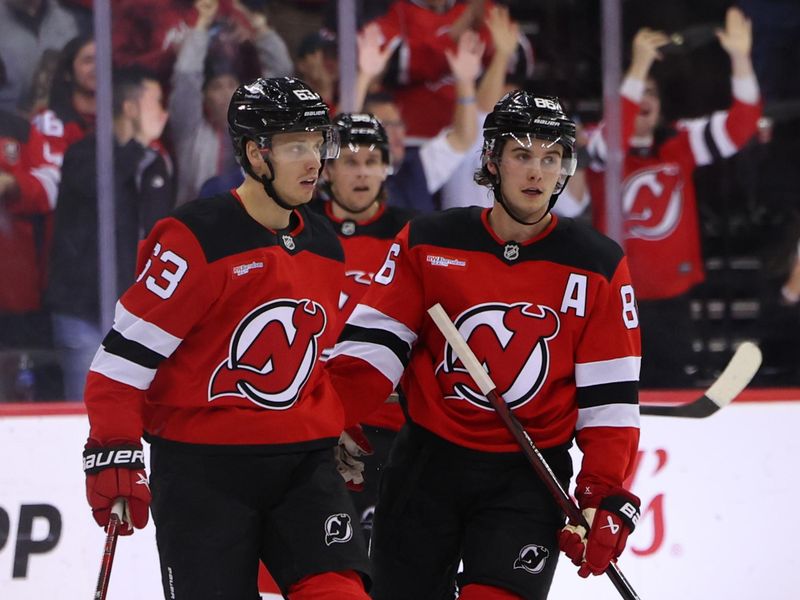 Nov 7, 2024; Newark, New Jersey, USA; New Jersey Devils left wing Jesper Bratt (63) and New Jersey Devils center Jack Hughes (86) celebrate a goal by Bratt against the Montreal Canadiens during the third period at Prudential Center. Mandatory Credit: Ed Mulholland-Imagn Images