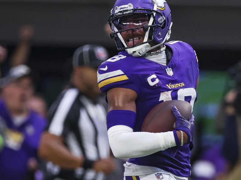 Minnesota Vikings wide receiver Justin Jefferson (18) carries the ball into the end zone during the second half of an NFL football game against the Los Angeles Chargers, Sunday, Sept.24, 2023 in Minneapolis. (AP Photo/Stacy Bengs)