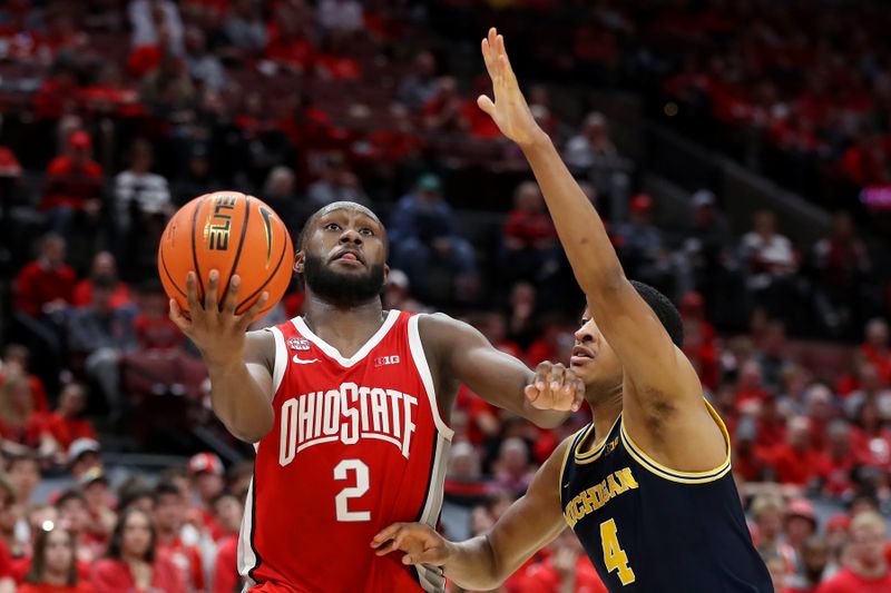 Mar 3, 2024; Columbus, Ohio, USA; Ohio State Buckeyes guard Bruce Thornton (2) takes the ball in for a layup as Michigan Wolverines guard Nimari Burnett (4) defends during the second half at Value City Arena. Mandatory Credit: Joseph Maiorana-USA TODAY Sports