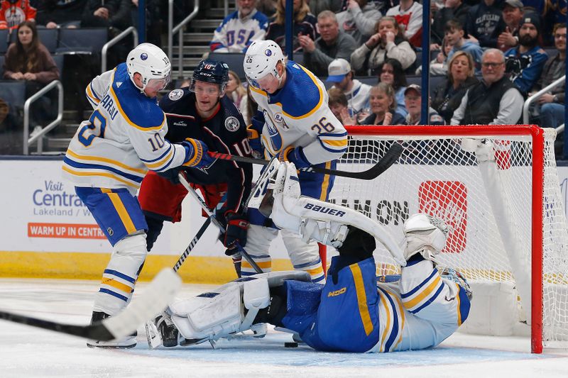 Feb 23, 2024; Columbus, Ohio, USA; Buffalo Sabres goalie Ukko-Pekka Luukkonen (1) makes a save as Columbus Blue Jackets left wing Dmitri Voronkov (10) looks for a rebound during the first period at Nationwide Arena. Mandatory Credit: Russell LaBounty-USA TODAY Sports