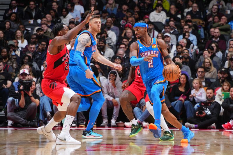 TORONTO, CANADA - DECEMBER 05:  Shai Gilgeous-Alexander #2 of the Oklahoma City Thunder handles he ball during the game against the Toronto Raptors on December 05, 2024 at the Scotiabank Arena in Toronto, Ontario, Canada.  NOTE TO USER: User expressly acknowledges and agrees that, by downloading and or using this Photograph, user is consenting to the terms and conditions of the Getty Images License Agreement.  Mandatory Copyright Notice: Copyright 2024 NBAE (Photo by Mark Blinch/NBAE via Getty Images)