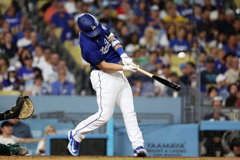 Aug 3, 2023; Los Angeles, California, USA;  Los Angeles Dodgers designated hitter Will Smith (16) hits an RBI single during the sixth inning against the Oakland Athletics at Dodger Stadium. Mandatory Credit: Kiyoshi Mio-USA TODAY Sports